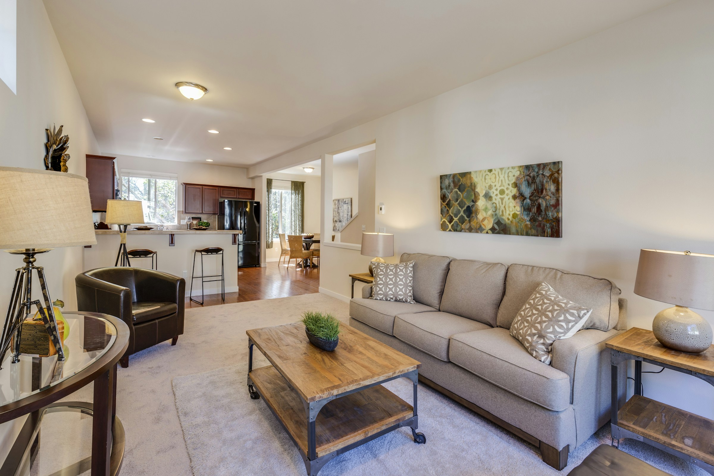 Bright furnished living room with an open kitchen